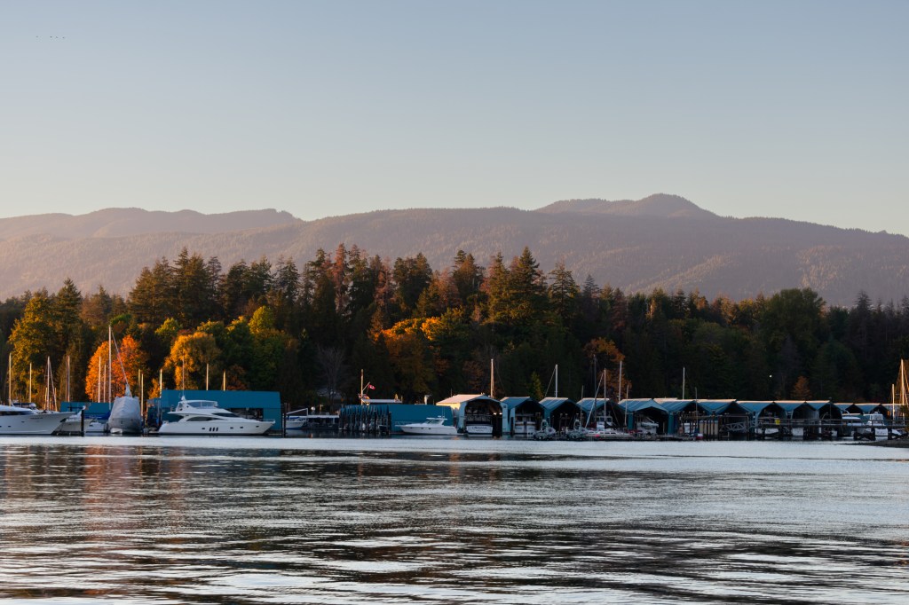 The Royal Yacht Club in Stanley Park with Autumn trees as the sun sets.
